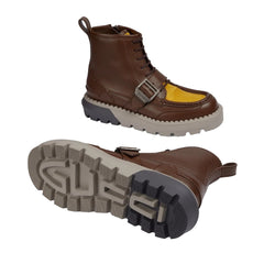 Brown leather boot with yellow sole on a light gray background