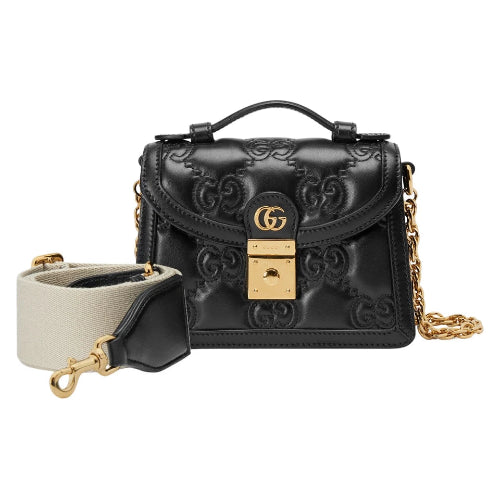 Black Gucci handbag with gold accents on a white background