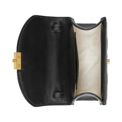 Black leather clutch with gold clasp on a white background