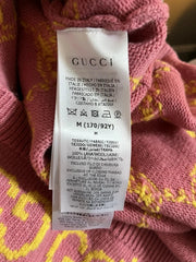 Gucci label on a pink fabric background