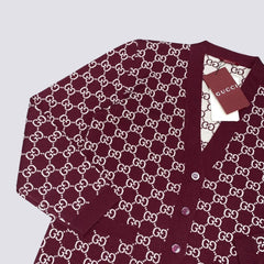 Maroon cardigan with white pattern on a light gray background