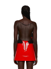 Person wearing a red skirt with black lace details on a white background