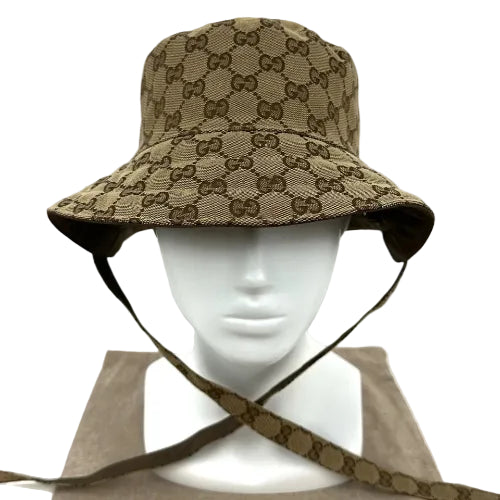 Beige bucket hat with brown pattern on a mannequin head against a light gray background