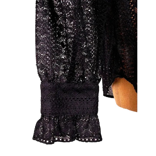 Close-up of black lace fabric with a blurred background