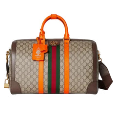 Designer handbag with brown leather and orange strap on a white background