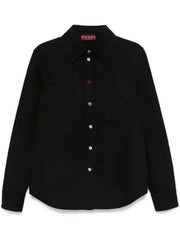 A black Gucci long-sleeve button-up shirt with a pointed collar and a small red Gucci label on the inner neck, displayed against a plain white background.