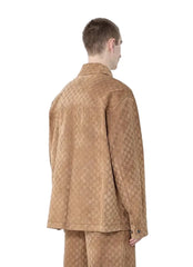 Person wearing a patterned outfit against a plain background