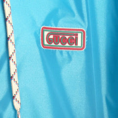 Close-up of a Gucci logo on a blue fabric background