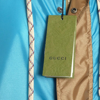 Gucci tag on a jacket with a blue background