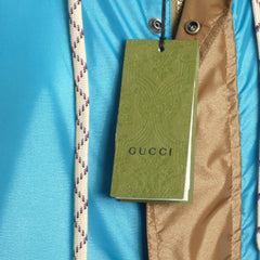 Gucci tag on a jacket with a blue background
