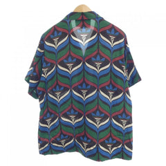 Colorful patterned shirt on a mannequin against a white background