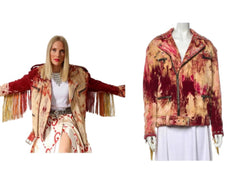 Woman wearing a colorful jacket with fringe and a mannequin displaying a similar jacket.