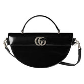 Black handbag with a prominent logo on a white background