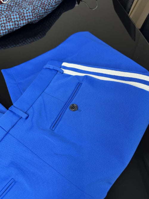 Blue pants with white stripes on a dark surface