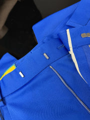 Close-up of a blue jacket with a brand logo on a dark background