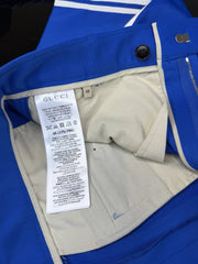 Close-up of a Gucci label inside a blue jacket with beige lining.