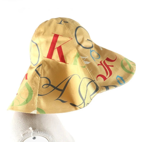 Yellow bucket hat with colorful letters on a mannequin head against a white background