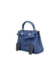 A blue leather handbag with a top handle and a front clasp, photographed against a plain light gray background.