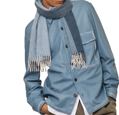 Person wearing a blue jacket and scarf on a white background