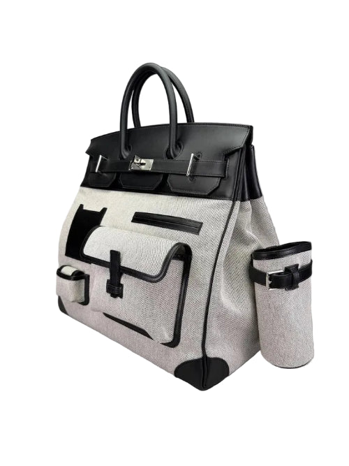 Black and white handbag with attached cup holder on a light gray background
