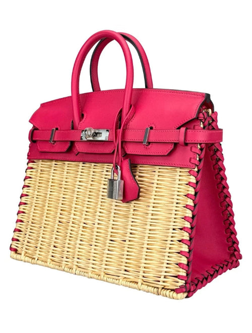 Pink handbag with wicker design on a white background