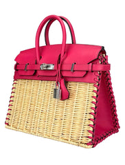 Pink handbag with wicker design on a white background