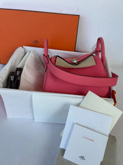 Close-up of a handbag with visible branding on a white background