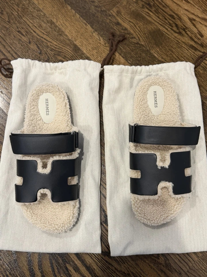 Pair of black and white sandals on a white background