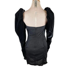 Black dress on a mannequin with a plain background