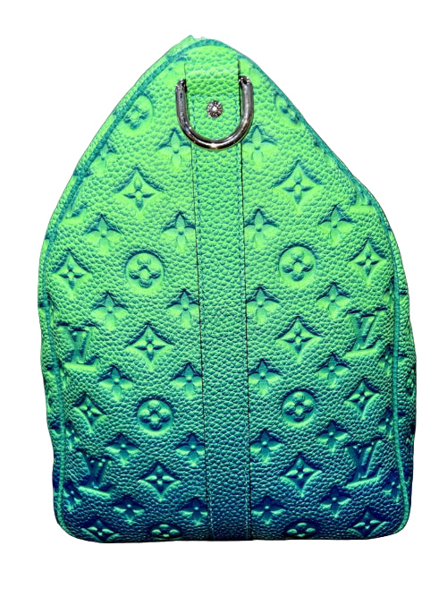 Green textured handbag with a silver clasp on a dark background