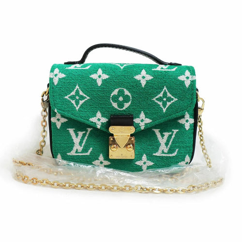 Green handbag with white monogram pattern on a white background