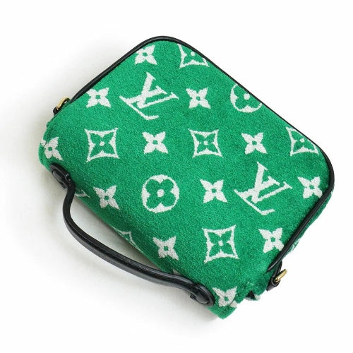 Green pouch with white monogram pattern on a white background