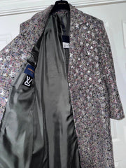 Floral patterned coat with a visible brand label on a white background