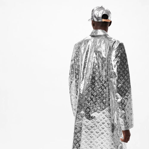 Person wearing a silver reflective jacket and cap on a white background