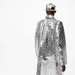 Person wearing a silver reflective jacket and cap on a white background