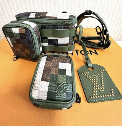 Green checkered pouch with a strap and tag on a beige surface