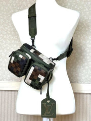 Green pixelated bag with a strap on a mannequin against a neutral background