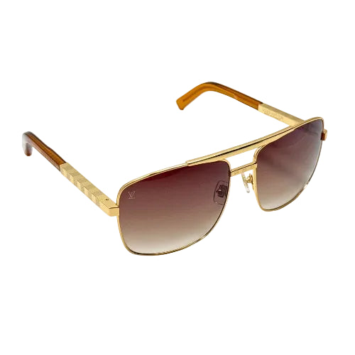 Gold-framed sunglasses with a gradient lens on a white background