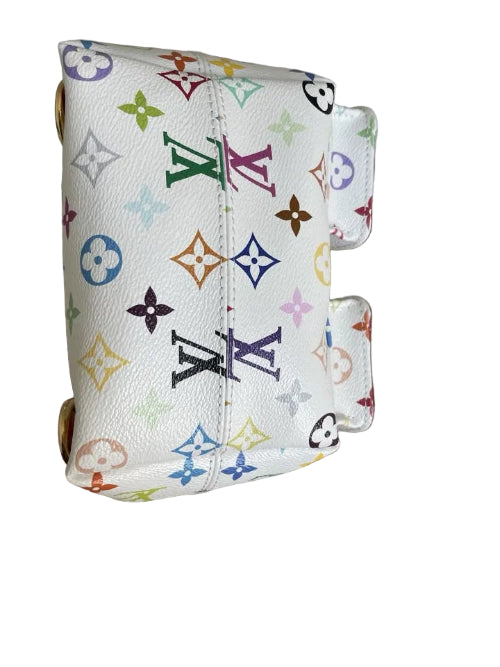 Multicolored patterned pouch held over a cardboard box on a light background