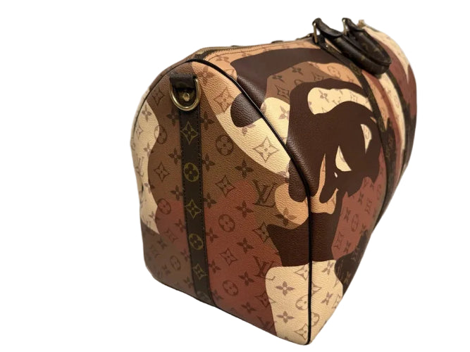 Designer handbag with monogram pattern on a light gray floor