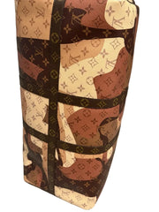 Louis Vuitton monogram patterned suitcase on a light gray floor.