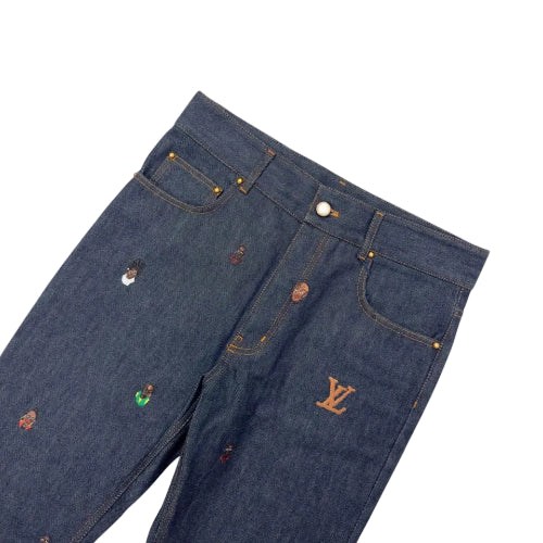 Close-up of dark blue jeans with colorful buttons on a blurred background