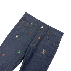 Close-up of dark blue jeans with colorful buttons on a blurred background