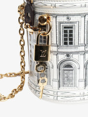 Designer handbag with gold lock and chain on a white background