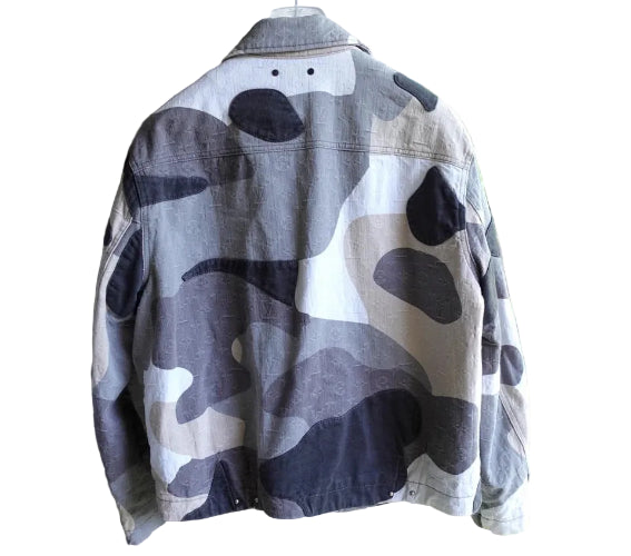 Camouflage-patterned jacket hanging on a stand with a blurred outdoor background