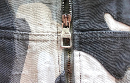 Close-up of a Louis Vuitton zipper on a denim jacket