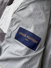 Louis Vuitton logo on a gray fabric background