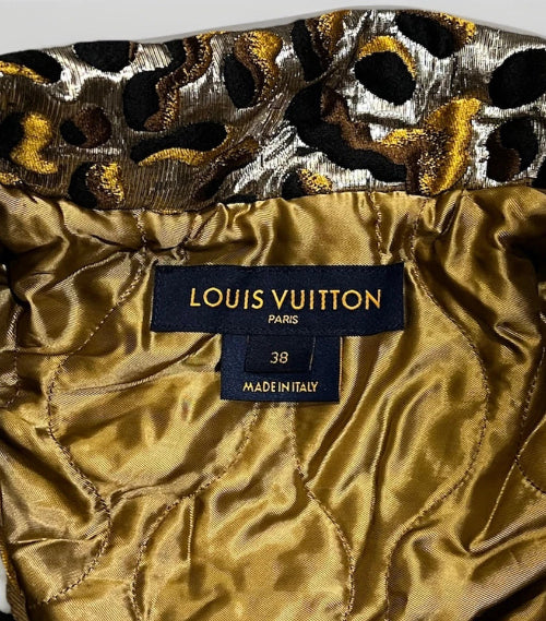 Louis Vuitton label on a gold fabric with leopard print pattern