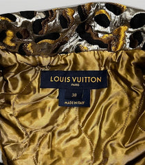 Louis Vuitton label on a gold fabric with leopard print pattern