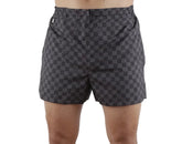 Checkered shorts worn by a person on a white background